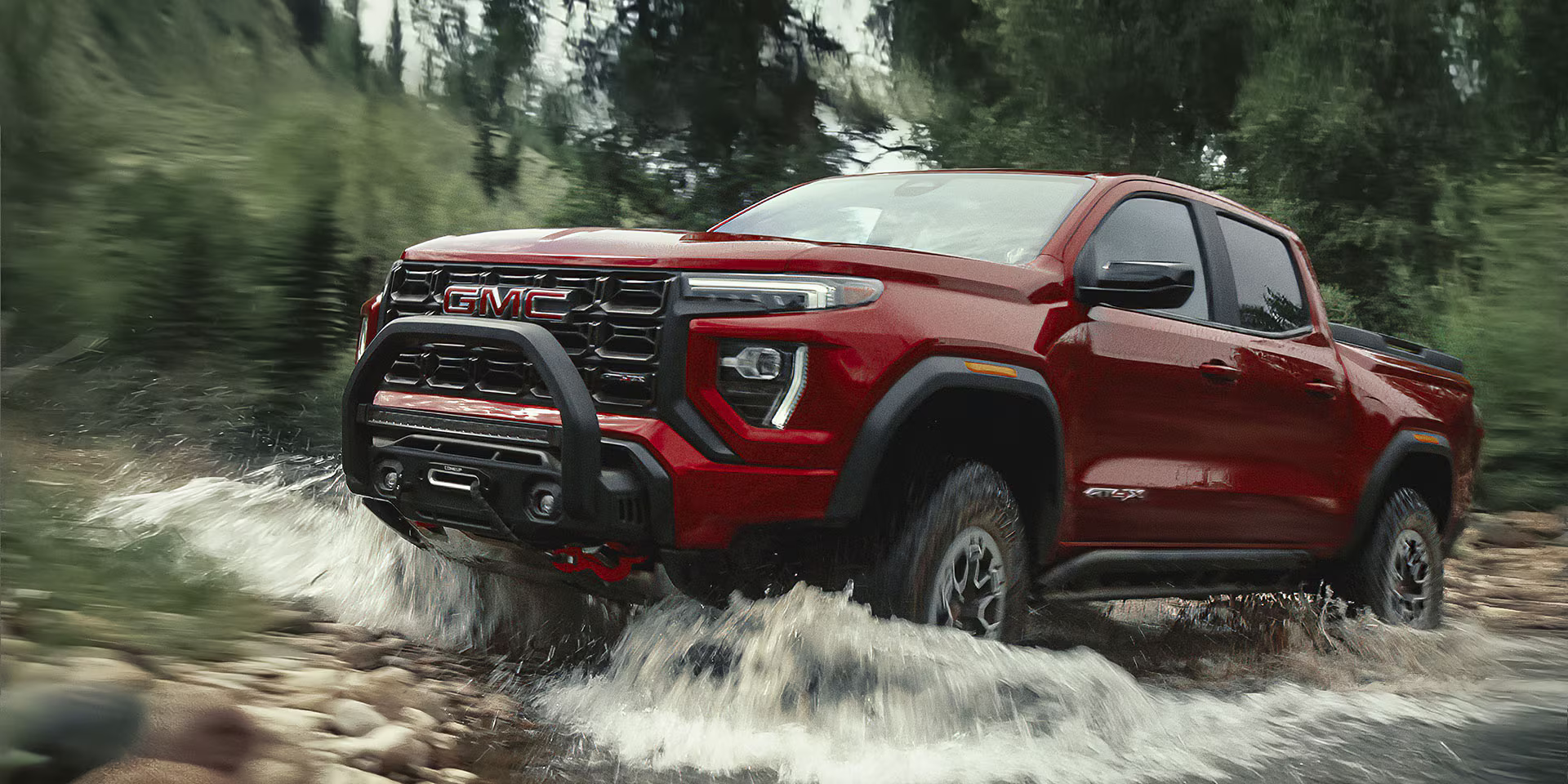 The 2026 GMC Canyon fording a river