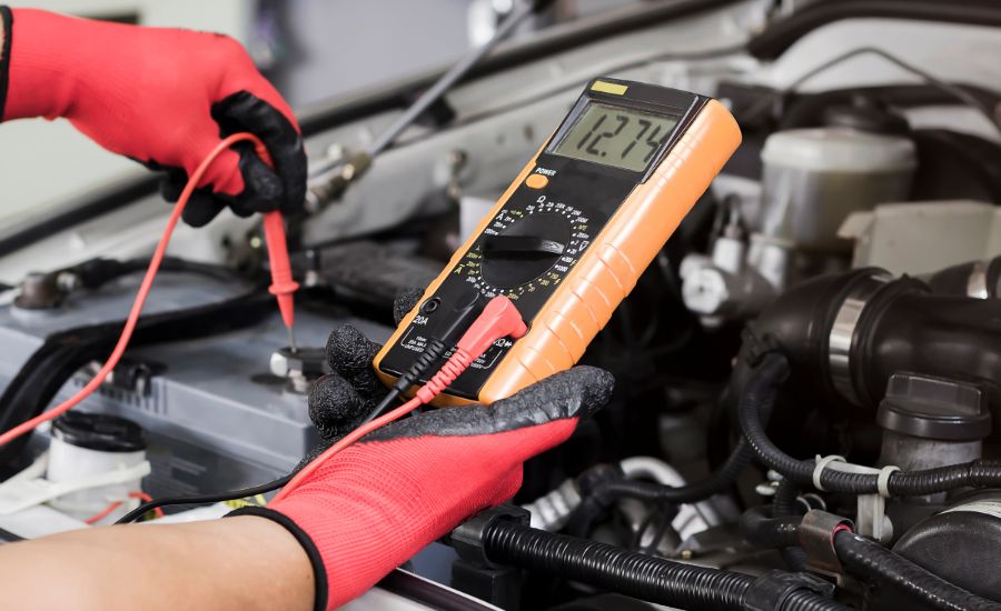 GMC service tech testing a battery