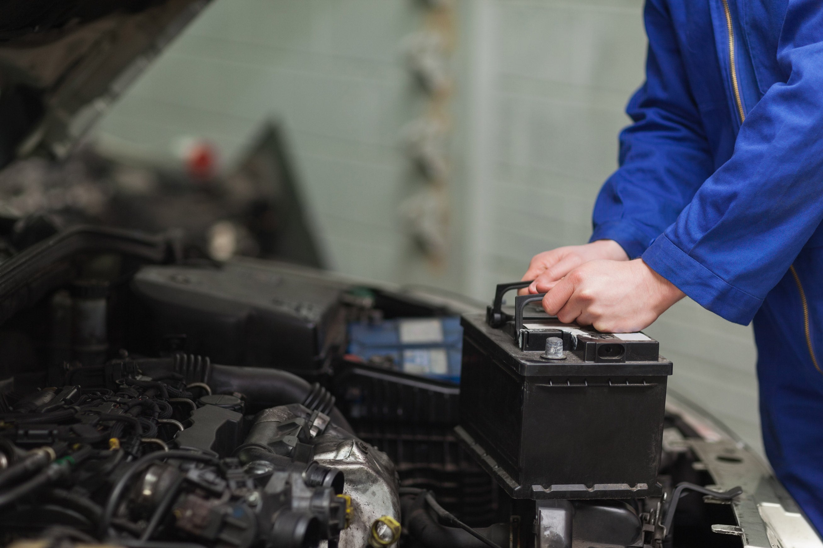 GMC service technician replacing a battery