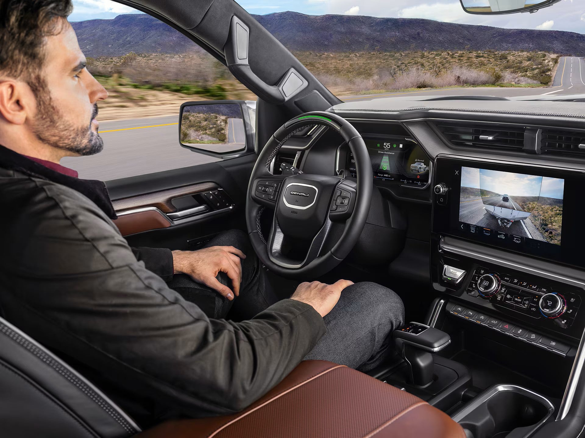 Interior view of a 2026 GMC Sierra 1500 driving hands-free on the highway using Super Cruise technology