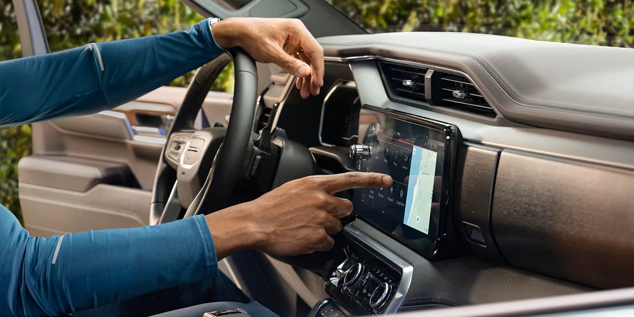 Interior display of a Certified Pre-Owned GMC showing OnStar and SiriusXM capability